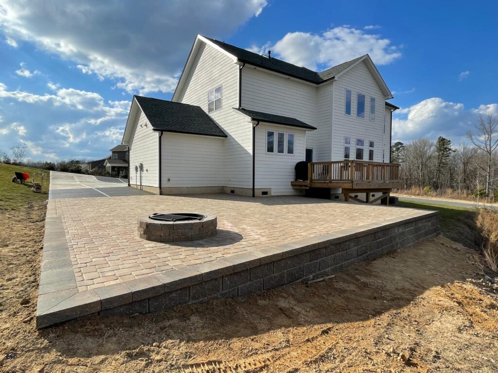 A beautifully designed outdoor area featuring a custom patio, seating, and lush landscaping, created by Mazzucco Construction for an elegant and functional outdoor space.